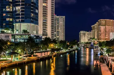 a city at night with a river with tall buildings at The W 1906 in Fort Lauderdale