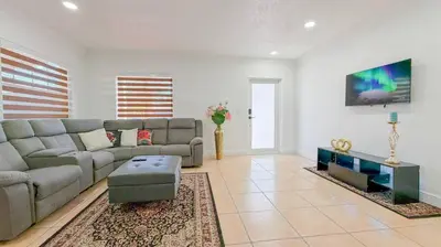 a living room with a couch and a tv at Modern & Central Miami Free Parking & WiFi in Miami