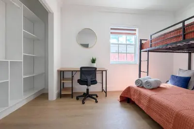 a bedroom with a desk and a bed and a bed and a chair at Modern & Central Miami Free Parking & WiFi in Miami