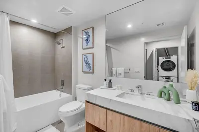 a bathroom with a sink and a toilet and a tub at 2BR Corner Suite MIA Wrap Balcony Rooftop Pool in Miami