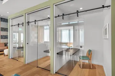 a room with glass doors and a table and a chair at 2BR Corner Suite MIA Wrap Balcony Rooftop Pool in Miami