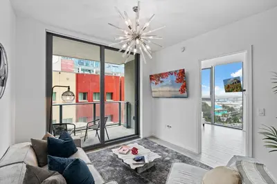 a living room with a couch and a chandelier at The Downtown Miami 2BR 2BA Luxury Stay in Miami