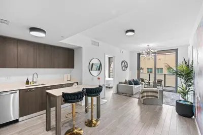 a kitchen and living room with a table and chairs at The Downtown Miami 2BR 2BA Luxury Stay in Miami