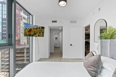 a bedroom with a bed and a window at The Downtown Miami 2BR 2BA Luxury Stay in Miami