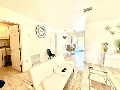 a living room with a white couch and a table at Better Experience Property in Miramar