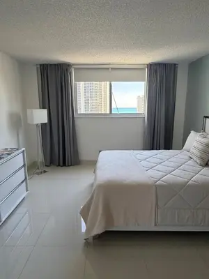 a bedroom with a bed and a large window at Exceptional apartment in Sunny Isles in Sunny Isles Beach