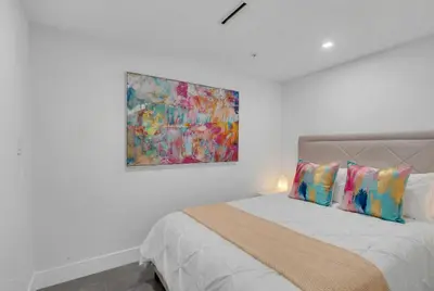 a bedroom with a bed with a painting on the wall at Huge Balcony Oceanfront 2 Bedrooms with Free Parking in Miami Beach