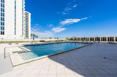 a large swimming pool in front of a building at Huge Balcony Oceanfront 2 Bedrooms with Free Parking in Miami Beach