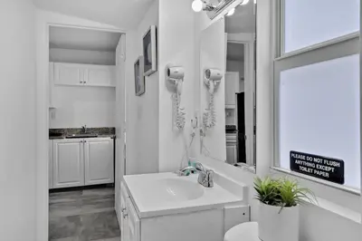 a white bathroom with a sink and a phone at Lovely 1 BR Walking Distance To Ocean - Suite 1 in Hollywood