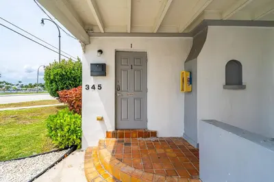 a front door of a house with a brick walkway at Lovely 1 BR Walking Distance To Ocean - Suite 1 in Hollywood