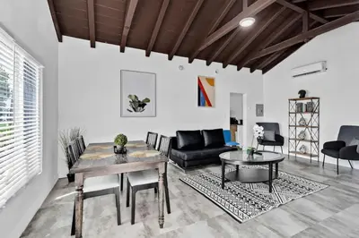 a living room with a table and a couch at Lovely 1 BR Walking Distance To Ocean - Suite 1 in Hollywood