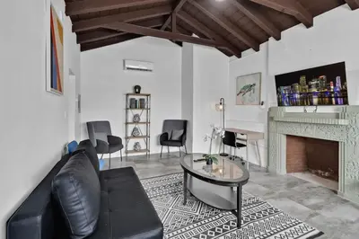 a living room with a couch and a fireplace at Lovely 1 BR Walking Distance To Ocean - Suite 1 in Hollywood