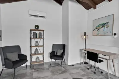 a room with a desk and two chairs and a table at Lovely 1 BR Walking Distance To Ocean - Suite 1 in Hollywood
