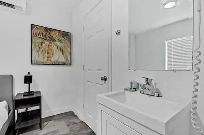 a white bathroom with a sink and a mirror at Cozy Studio 2 Blocks from the Beach - Unit #3 in Hollywood