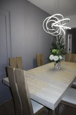 a dining room with a table and a chandelier at Modern house with pool close to HARD ROCK in Pembroke Pines