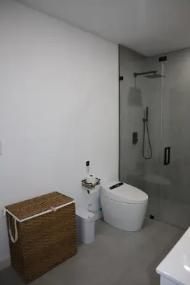 a bathroom with a toilet and a glass shower at Modern house with pool close to HARD ROCK in Pembroke Pines