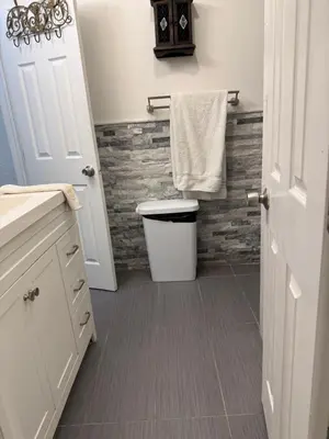 a bathroom with a toilet and a towel at My Help Comes from The Lord Miami in Palmetto Bay