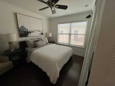 a bedroom with a bed and a ceiling fan at Beachside One Bedroom Condo with Pool Access in Hollywood
