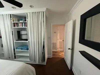 a bedroom with a bed and a book shelf at Beachside One Bedroom Condo with Pool Access in Hollywood