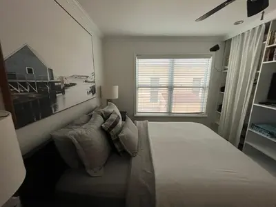 a white bedroom with a bed and a window at Beachside One Bedroom Condo with Pool Access in Hollywood