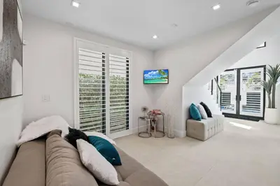 a living room with a couch and a window at Las Olas Villa in Fort Lauderdale