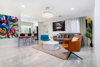 a living room with a couch and a table and chairs at Tropical Retreat- Heated Pool 3 Miles to the Beach in Fort Lauderdale