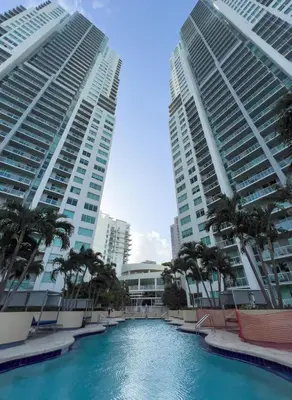 a swimming pool in the middle of two tall buildings at The Vizcayne Vibe- Sauna Pool and Sundeck in Miami