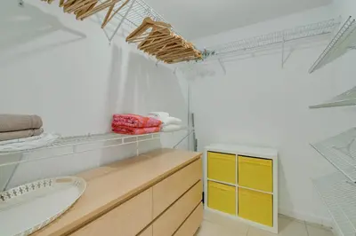 a bathroom with a yellow cabinet and a sink at Midtown Rouge- Condo with City Views Pool & Gym in Miami