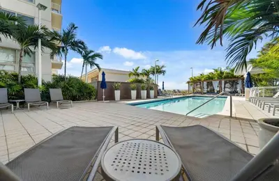 a swimming pool with chairs and a resort at Midtown Rouge- Condo with City Views Pool & Gym in Miami