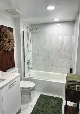 a bathroom with a tub and a toilet and a sink at Tropical Nest Residence in Hollywood