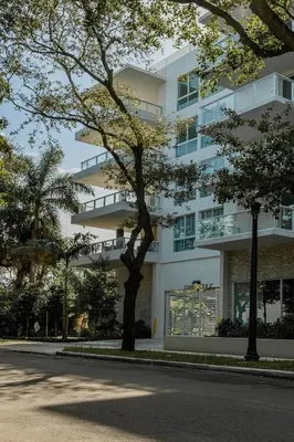 a white building with a tree in front of it at Tropical Nest Residence in Hollywood