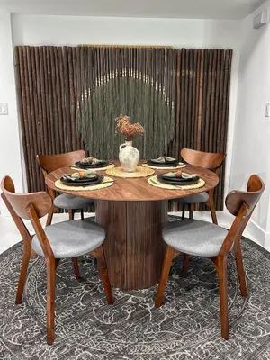 a wooden table with chairs and a vase on it at Tropical Nest Residence in Hollywood