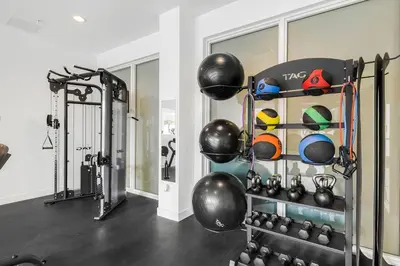 a gym with a rack of balls and weights at Pool & Gym | King Bed | Downtown Hollywood in Hollywood