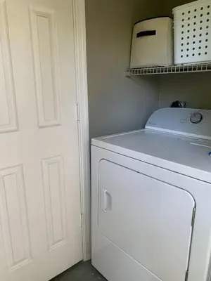 a washer and dryer in a kitchen next to a door at Central Fort Lauderdale 2BR Cottage Near Beach in Fort Lauderdale
