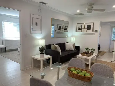 a living room with a couch and a table at Central Fort Lauderdale 2BR Cottage Near Beach in Fort Lauderdale