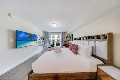 a bedroom with a large white bed in a room at Sky-High Urban Sanctuary with Coastal Glimpses in Miami