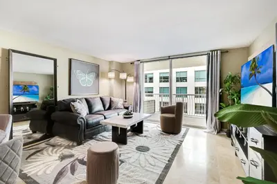 a living room with a couch and a table at Sky-High Urban Sanctuary with Coastal Glimpses in Miami