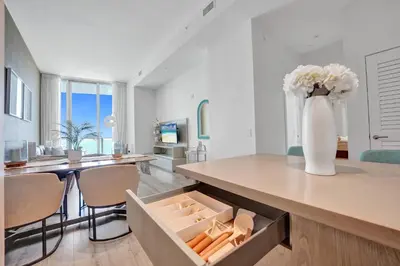 a vase of flowers in a kitchen with a table at Beachfront Luxe Condo Sunrise Oceanview Balcony in Hollywood