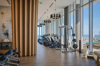 a gym with a row of treadmills and ellipticals at Beachfront Luxe Condo Sunrise Oceanview Balcony in Hollywood