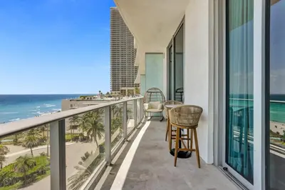 a balcony with a view of the ocean at Beachfront Luxe Condo Sunrise Oceanview Balcony in Hollywood