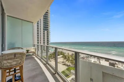 a balcony with a view of the ocean at Beachfront Luxe Condo Sunrise Oceanview Balcony in Hollywood