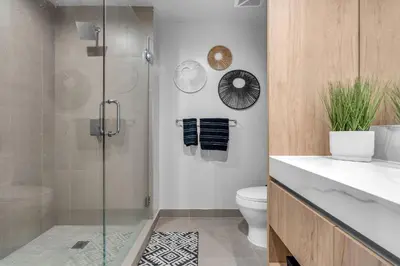 a bathroom with a glass shower and a toilet at Modern Chic 1BR Downtown with Rooftop Pool & Views in Miami