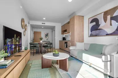 a living room with a couch and a table at Modern Chic 1BR Downtown with Rooftop Pool & Views in Miami