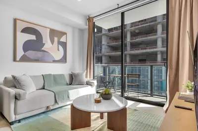 a living room with a couch and a table at Modern Chic 1BR Downtown with Rooftop Pool & Views in Miami
