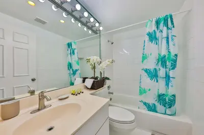 a bathroom with a sink and a toilet and a shower curtain at Zero Mile Villa Start your journey in Hollywood