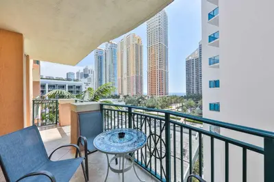 a balcony with a table and chairs and buildings at Blue Horizon at Sunny Isles King David in Sunny Isles Beach