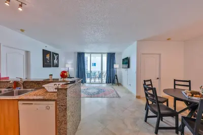 a kitchen and living room with a table and chairs at Blue Horizon at Sunny Isles King David in Sunny Isles Beach