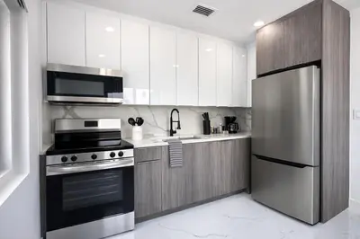 a kitchen with a stainless steel refrigerator and a stove at Luxury 1 King BR Retreat near Calle Ocho in Miami