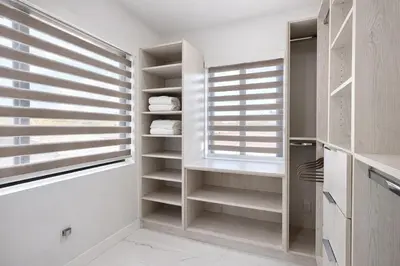 a walk in closet with white walls and wooden closets at Luxury 1 King BR Retreat near Calle Ocho in Miami
