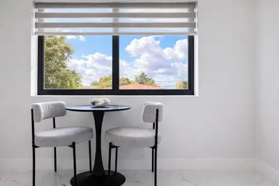 a table and two chairs in front of a window at Luxury 1 King BR Retreat near Calle Ocho in Miami
